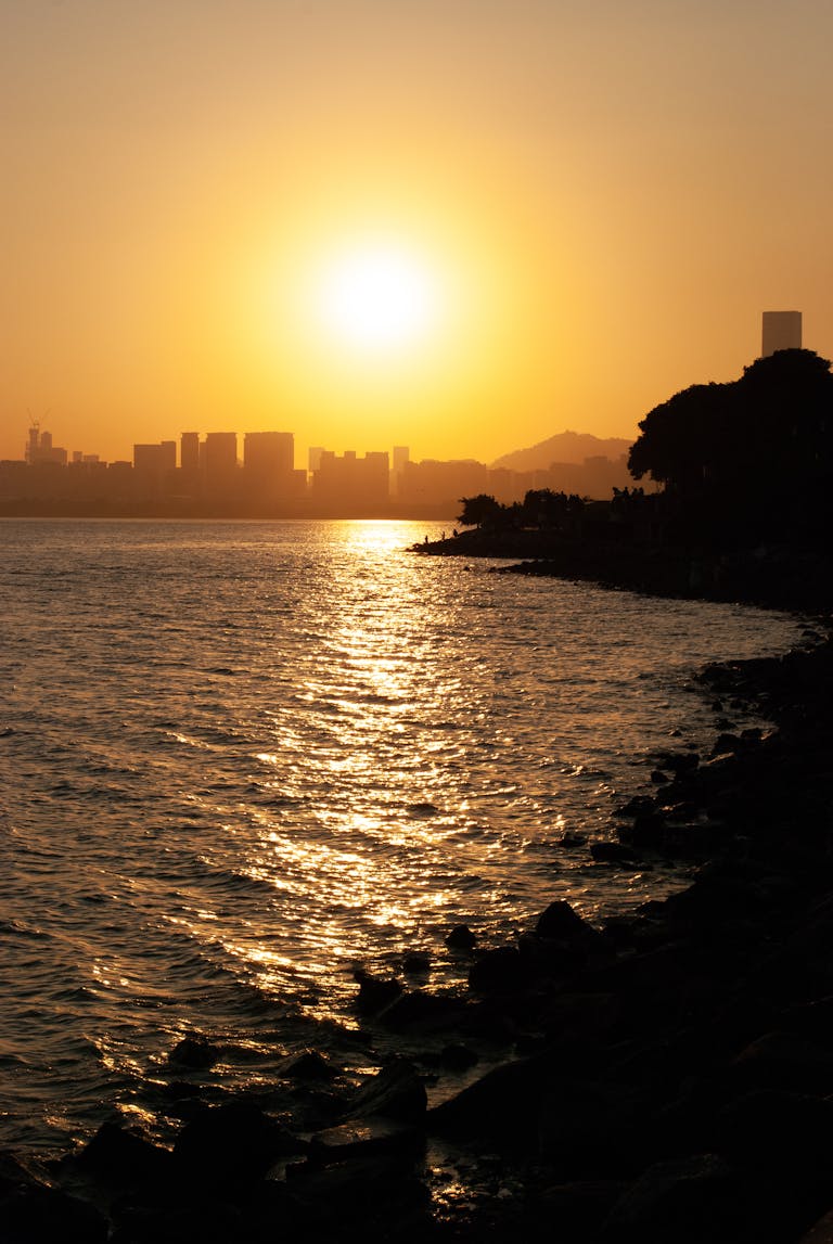 Beautiful sunset over the Shenzhen skyline with reflective waterfront, capturing the serene ambiance of the city.