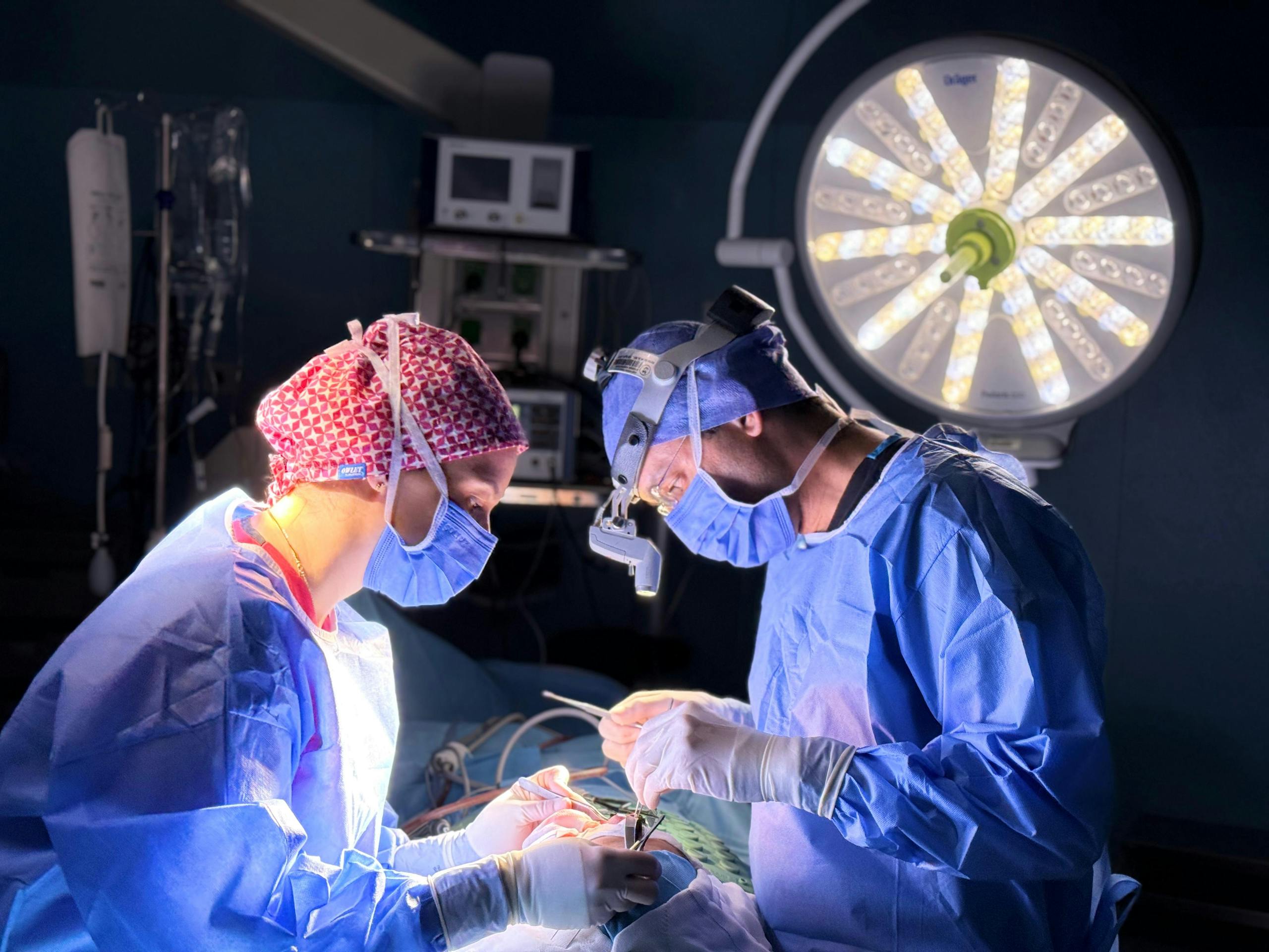 Professional surgical team in action in an operating room with focus on precision and teamwork.