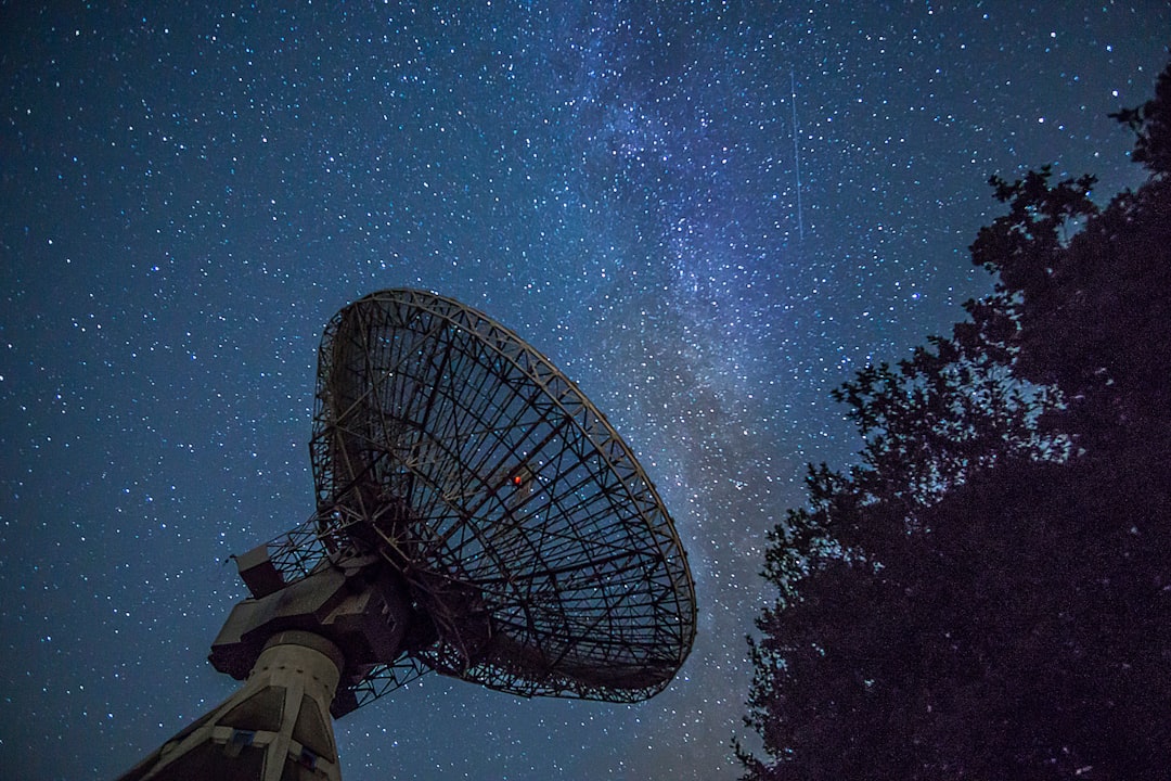White satellite dish under blue sky during night time