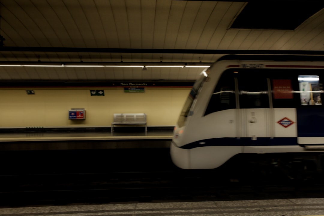 A white train pulling into a train station