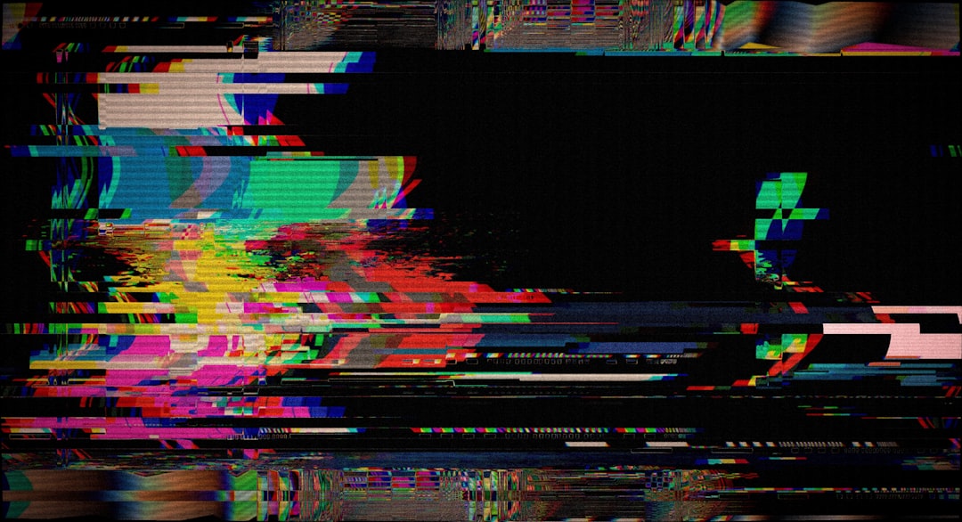 Abstract colorful digital static noise on black screen