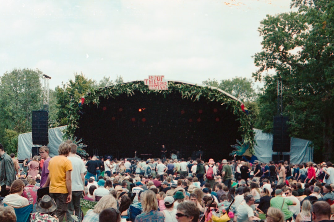 A large group of people sitting in front of a stage