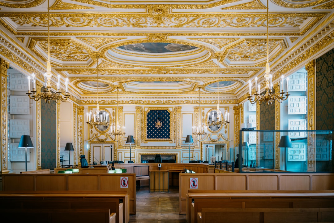 Ornate courtroom with gilded decorations and chandeliers