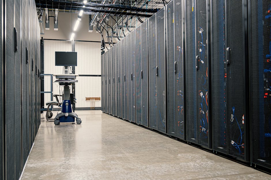 Row of GPU server racks in a modern data center, illuminated with blue lighting, showing dense compute infrastructure.