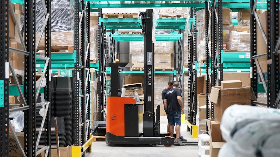 Warehouse view showing many identical robots or robot frames lined up in storage racks, illustrating scale and the idea of mass deployment.