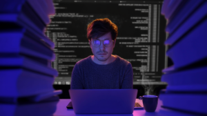 Developer working in a terminal at a desk in a dimly lit office