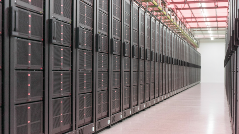 Aisle inside a modern cloud data center with rows of server racks.
