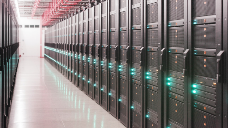 Rows of server racks in a modern data center with blue lighting