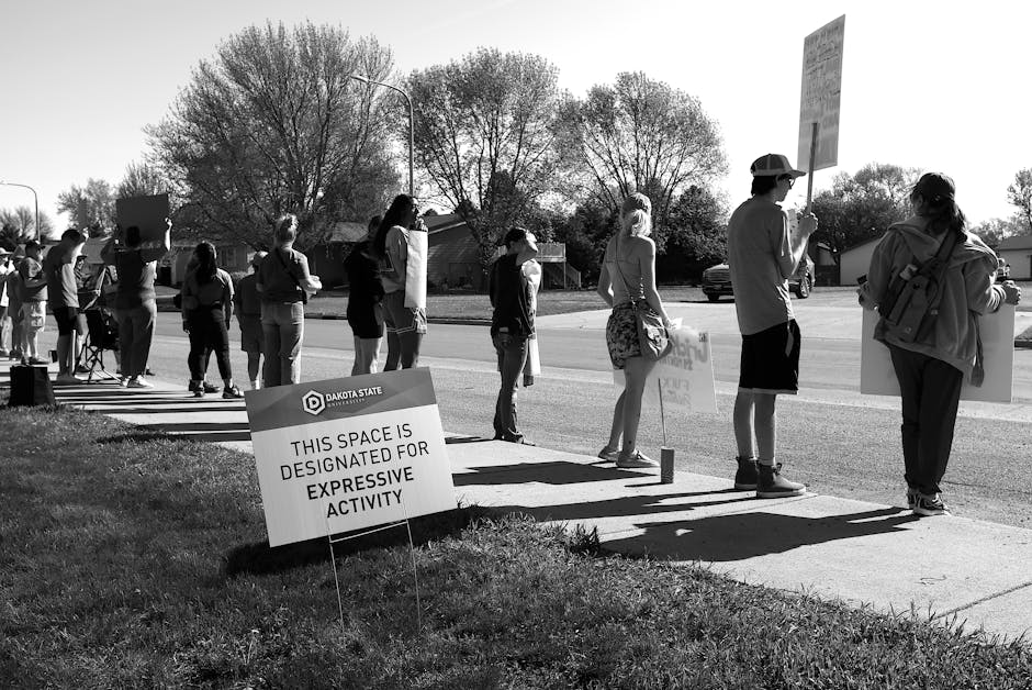 Yard signs in a suburban neighborhood showing local protest against a development project.