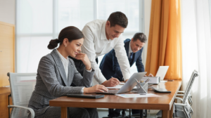Office workers using laptops in a modern workplace
