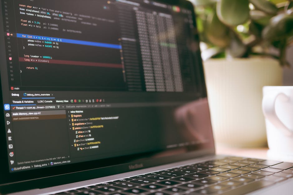 A software developer debugging code on a laptop
