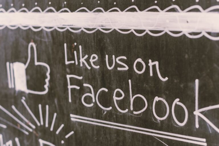 foreign meme: A person holding a smartphone showing a Facebook social feed.