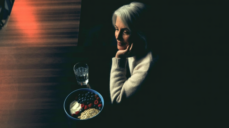 prebiotics and probiotics: Older adult eating a gut-healthy meal in warm natural light
