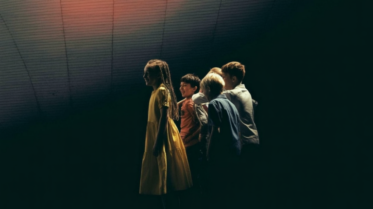 generation alpha: A diverse group of teenagers and children standing together in a bright urban setting.