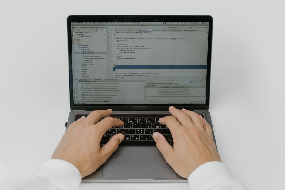 AI coding agent: Software engineer coding on a laptop in a modern workspace
