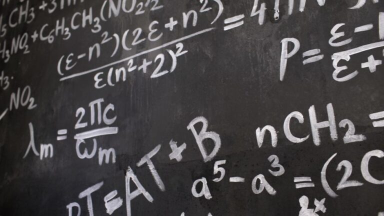 yuji tachikawa claude physics problem: A theoretical physicist writing equations on a blackboard
