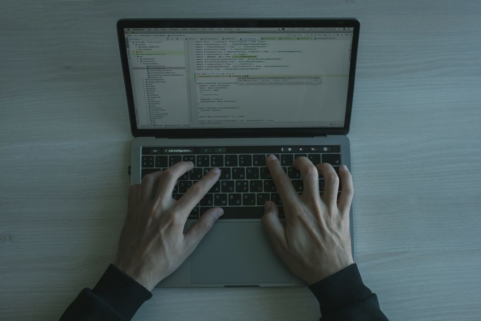 claude opus 5 coding: Anthropic Claude interface on a laptop in a developer workspace