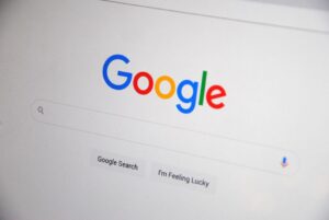 claude shared chats google search: Laptop screen showing the Claude chatbot interface, suggesting searchable shared chat links.