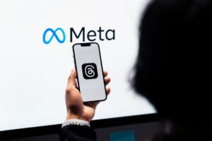 meta new mexico youth safety lawsuit: Teenager holding a smartphone while using social media