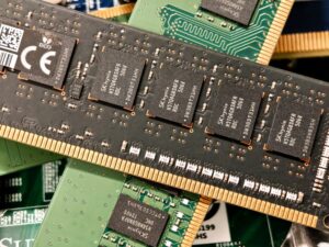 AMD motherboard with processor socket and four DDR memory slots populated with RAM modules.