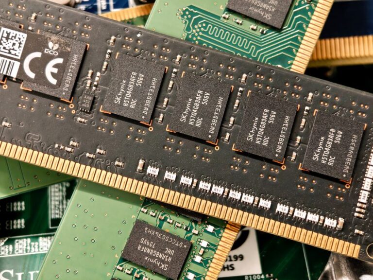 AMD motherboard with processor socket and four DDR memory slots populated with RAM modules.