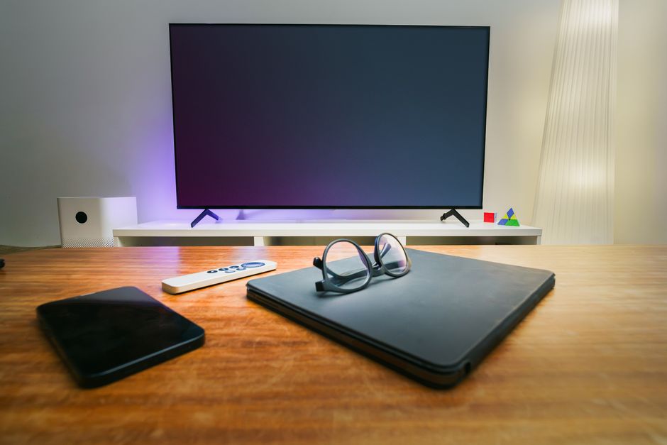 LG OLED television in a living room with nearby connected devices