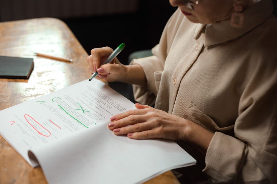 A researcher reviews and annotates printed paper drafts